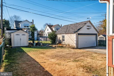 a view of a house with a yard and garage