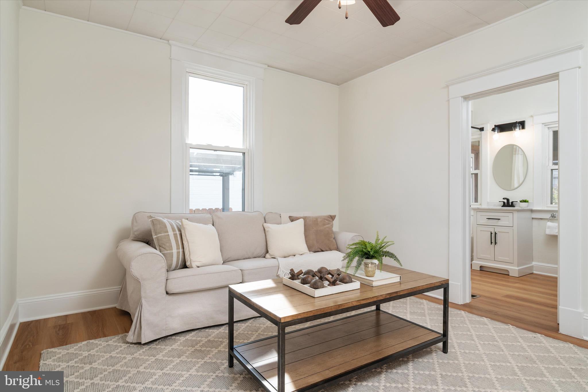 3827 Echodale Avenue Baltimore, MD 21206 - Photo 8 of 36 a living room with furniture and a rug