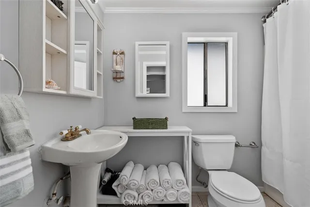 a bathroom with a toilet a sink and a mirror