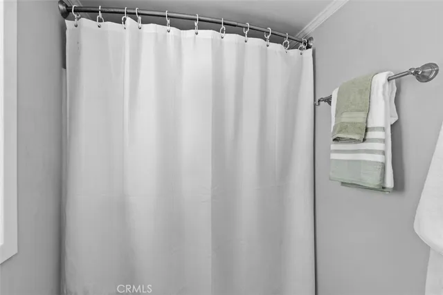 a bathroom with a shower curtain and a sink