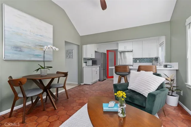 a living room with furniture and a dining table with kitchen view