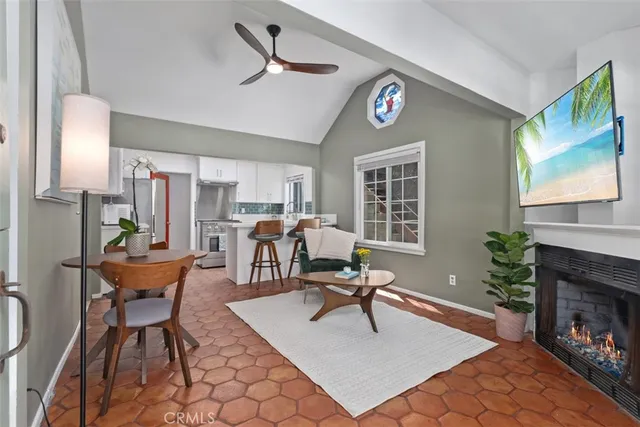 a living room with furniture a fireplace and a flat screen tv