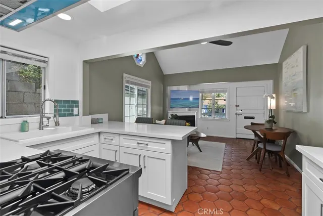 a kitchen with a stove and white cabinets