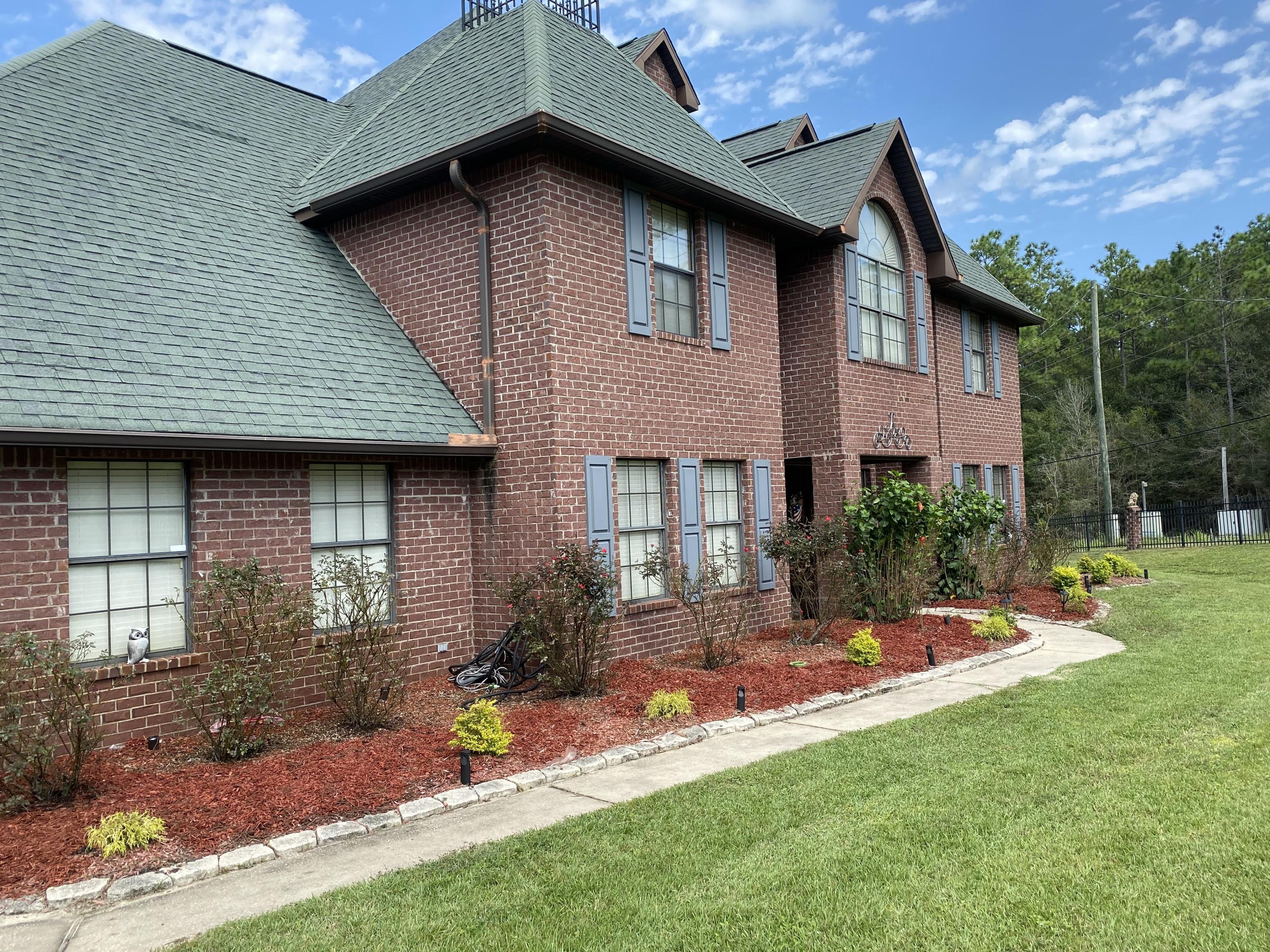 100 Sioux Circle Crestview, FL 32536 - Photo 1 of 36 a front view of a house with a yard table and chairs