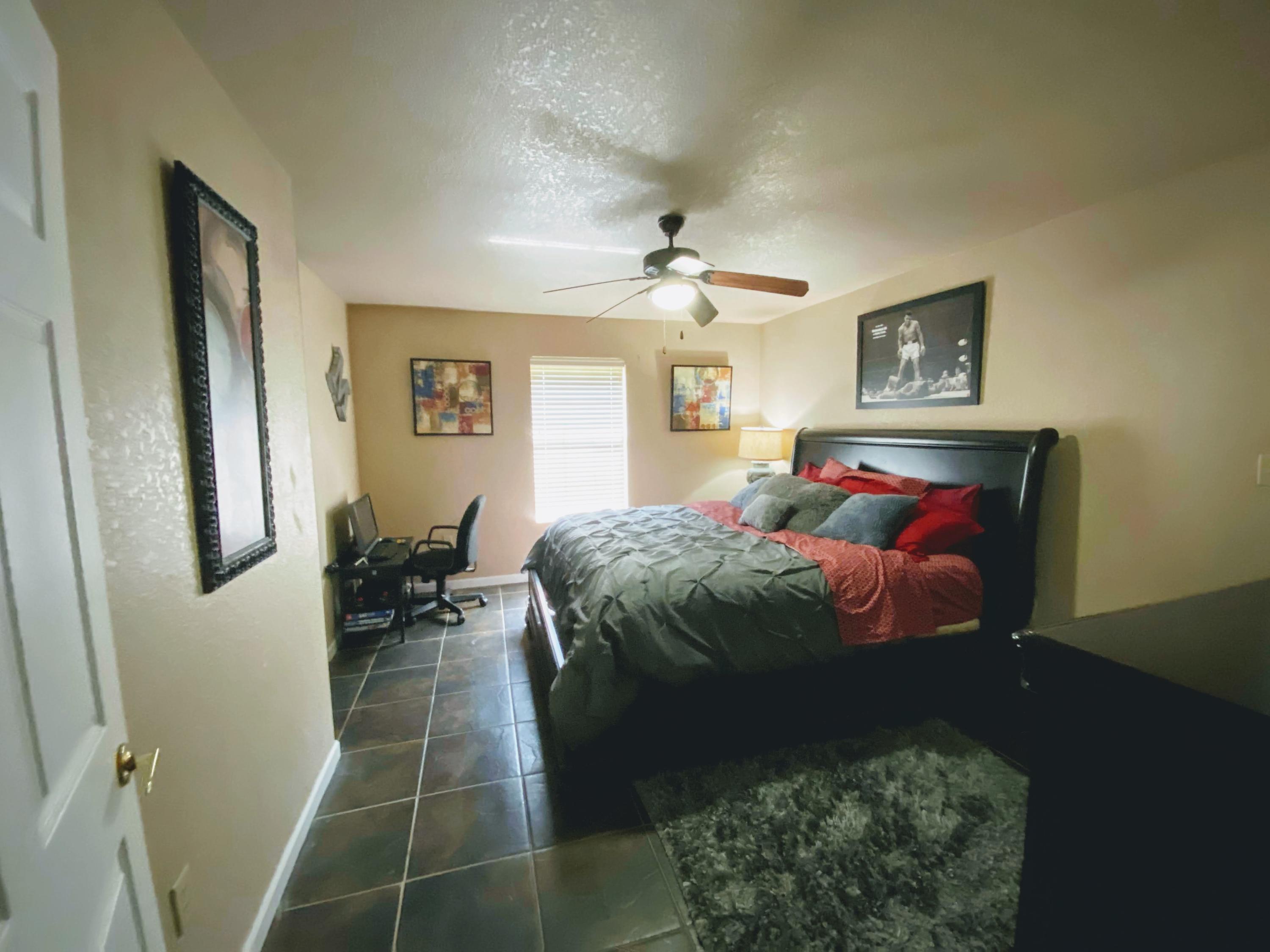 100 Sioux Circle Crestview, FL 32536 - Photo 14 of 36 a bedroom with a bed and a chandelier