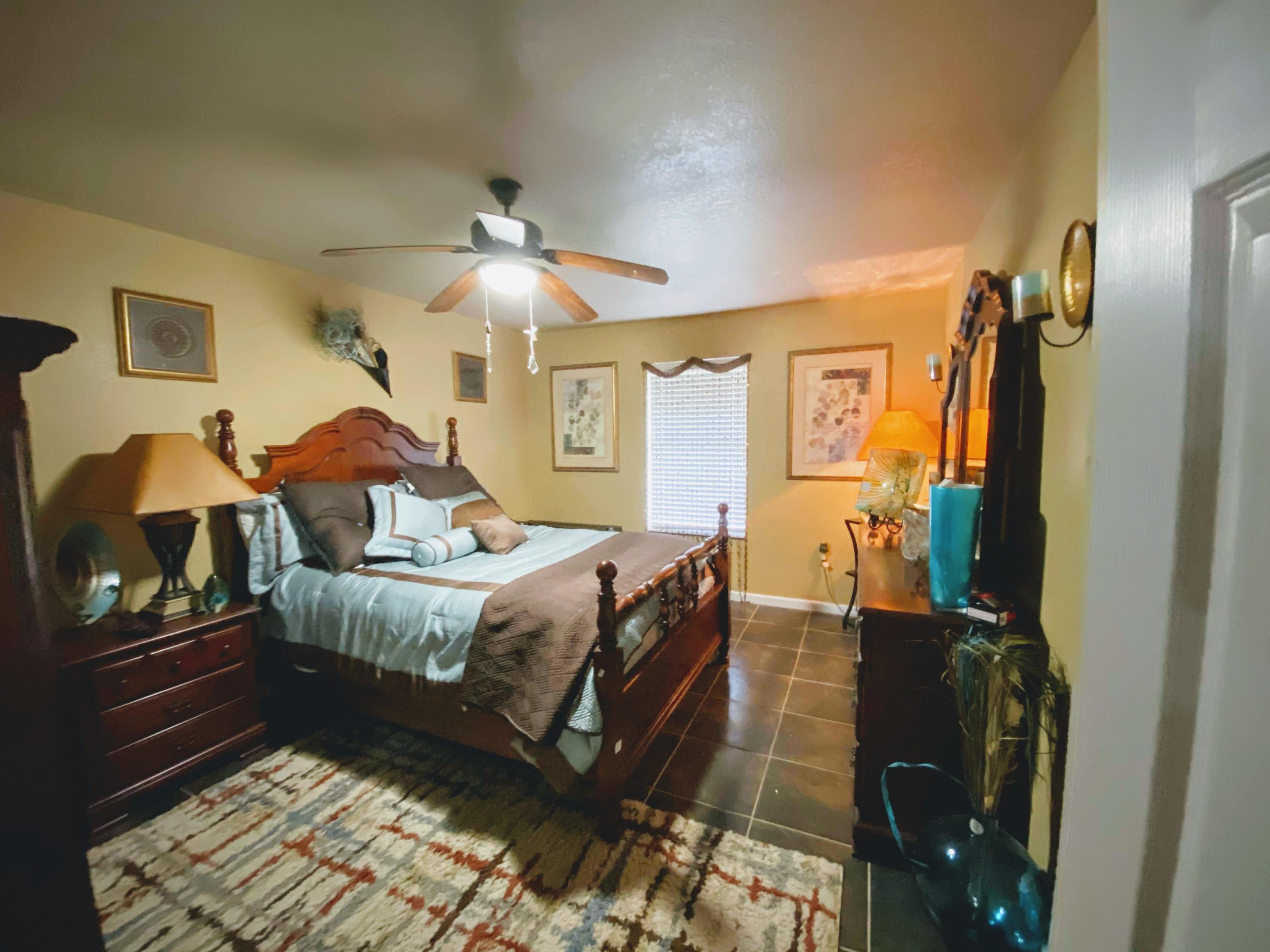 100 Sioux Circle Crestview, FL 32536 - Photo 18 of 36 a spacious bedroom with a bed and a chandelier