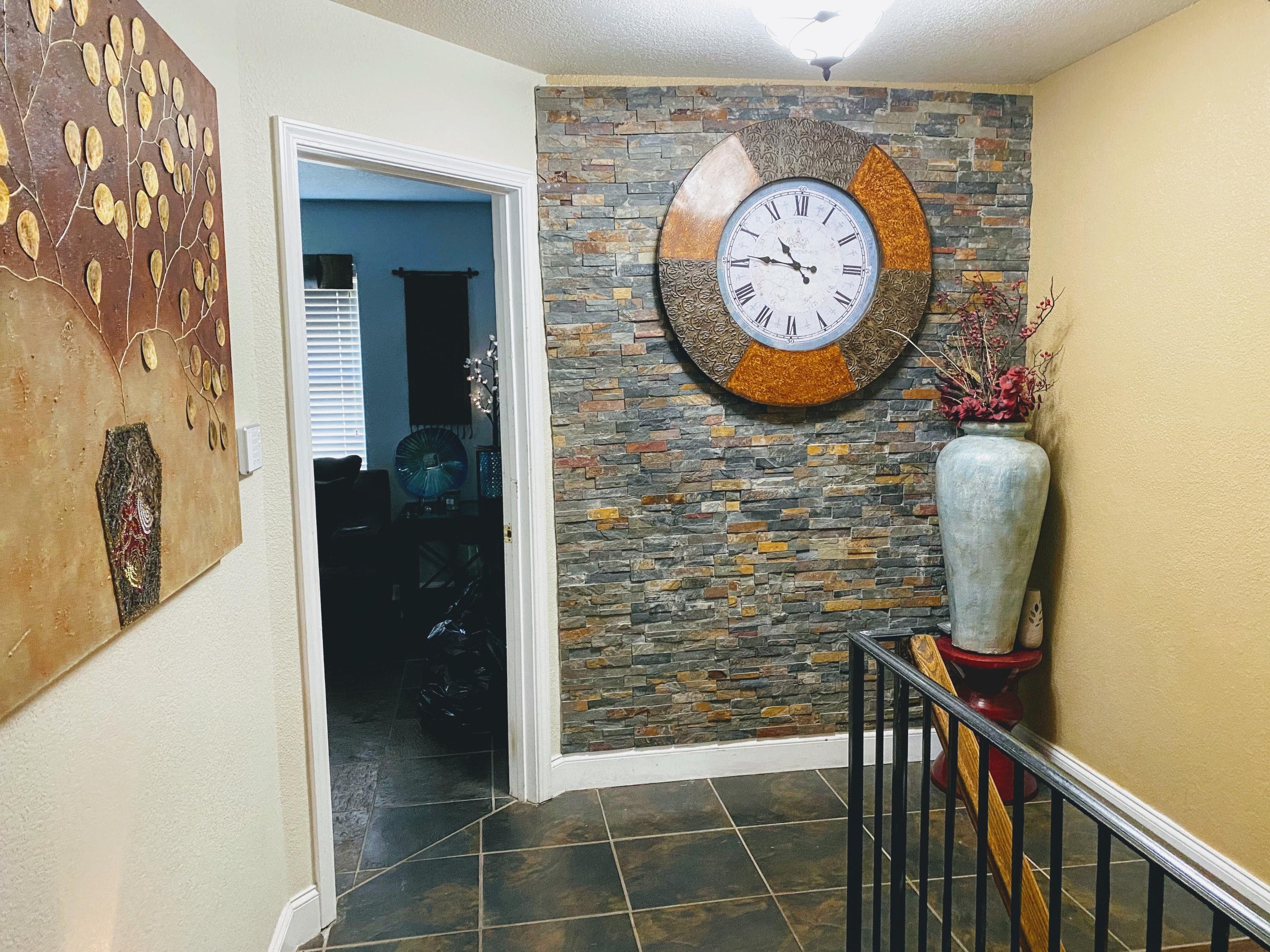 100 Sioux Circle Crestview, FL 32536 - Photo 20 of 36 a view of a hallway with paintings on the wall