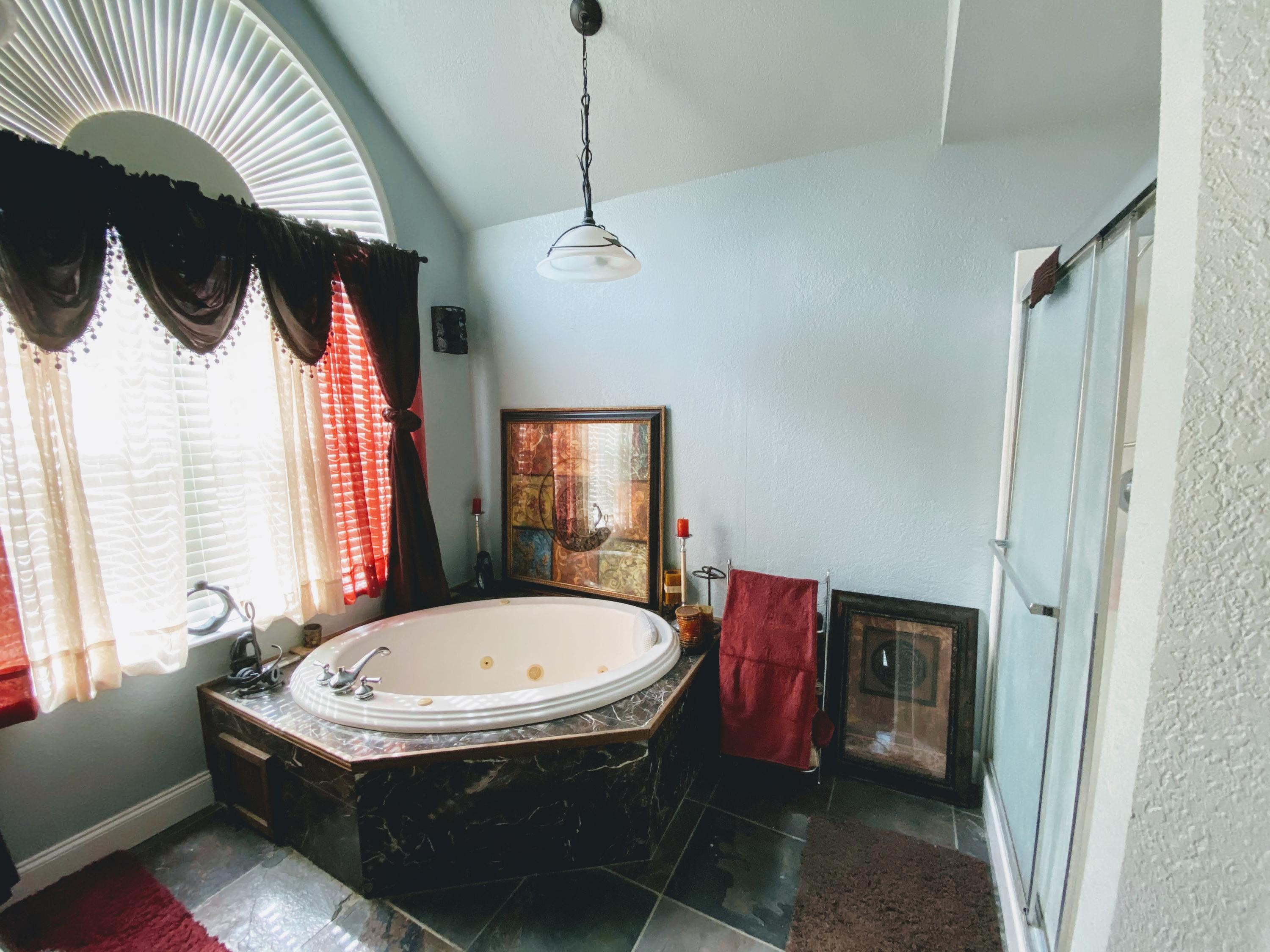 100 Sioux Circle Crestview, FL 32536 - Photo 22 of 36 a bathroom with a bathtub and a shower