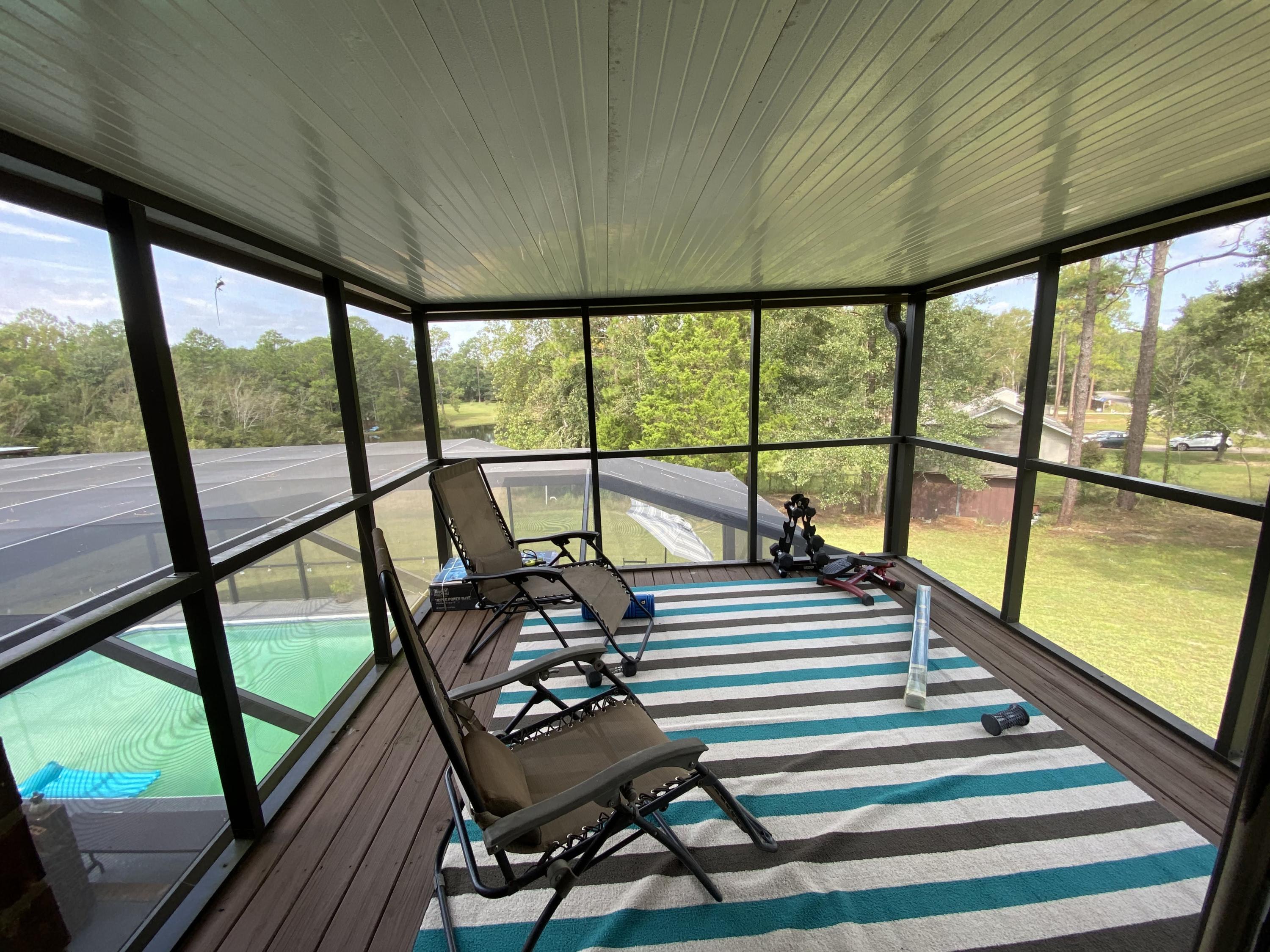 100 Sioux Circle Crestview, FL 32536 - Photo 23 of 36 a balcony with chairs and wooden floor