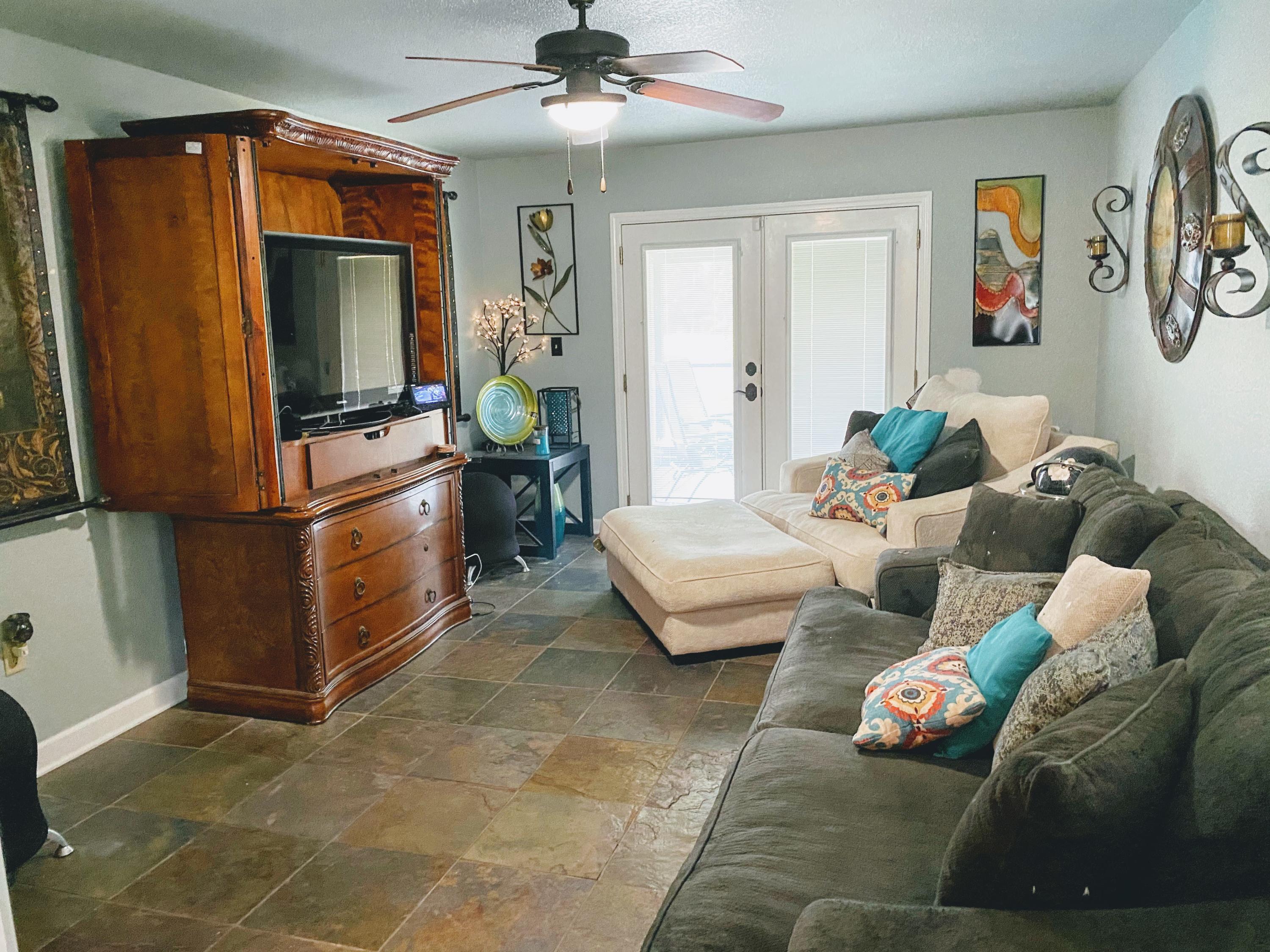 100 Sioux Circle Crestview, FL 32536 - Photo 24 of 36 a living room with furniture and a flat screen tv