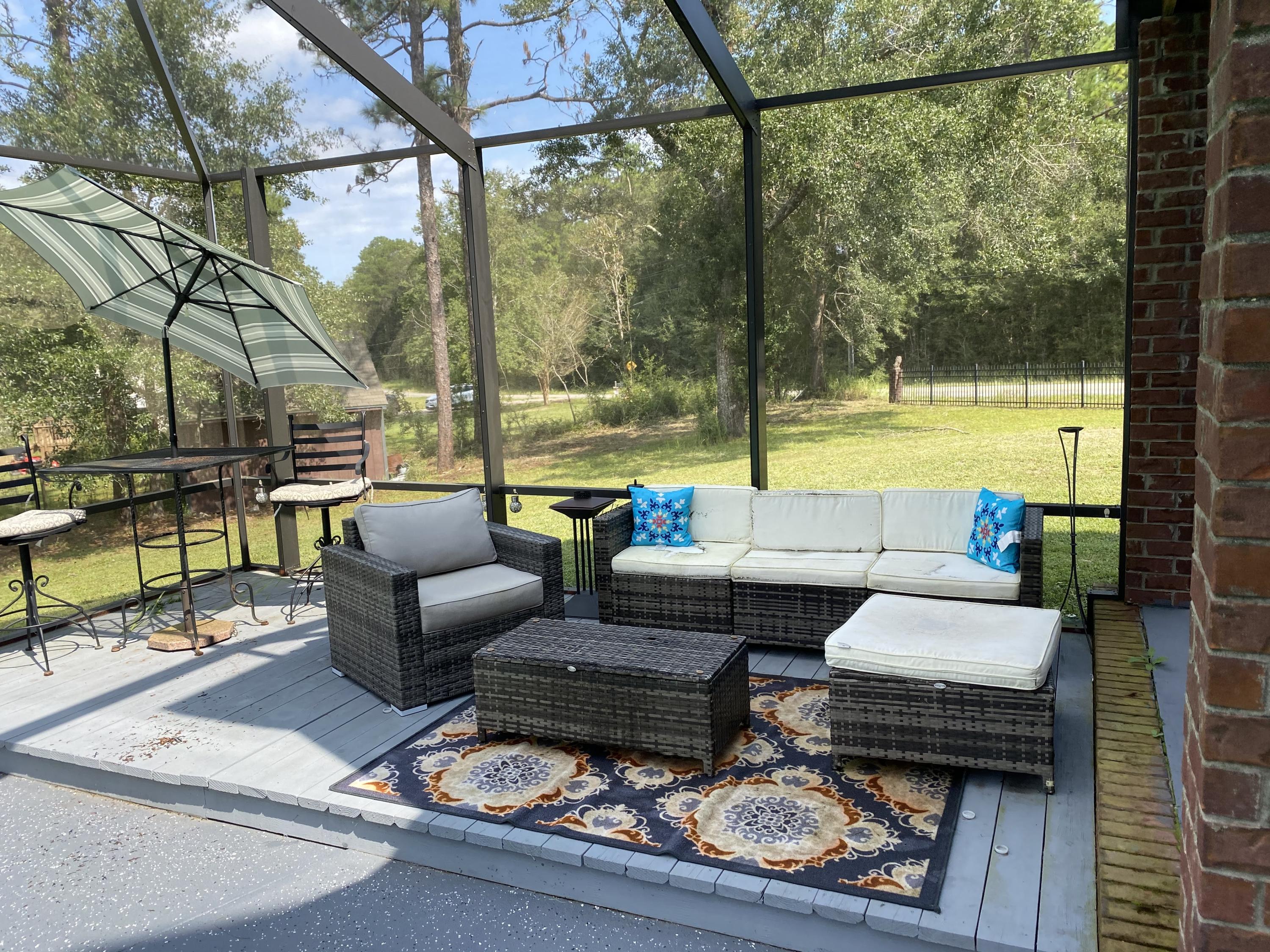 100 Sioux Circle Crestview, FL 32536 - Photo 30 of 36 a building outdoor space with patio and glass windows