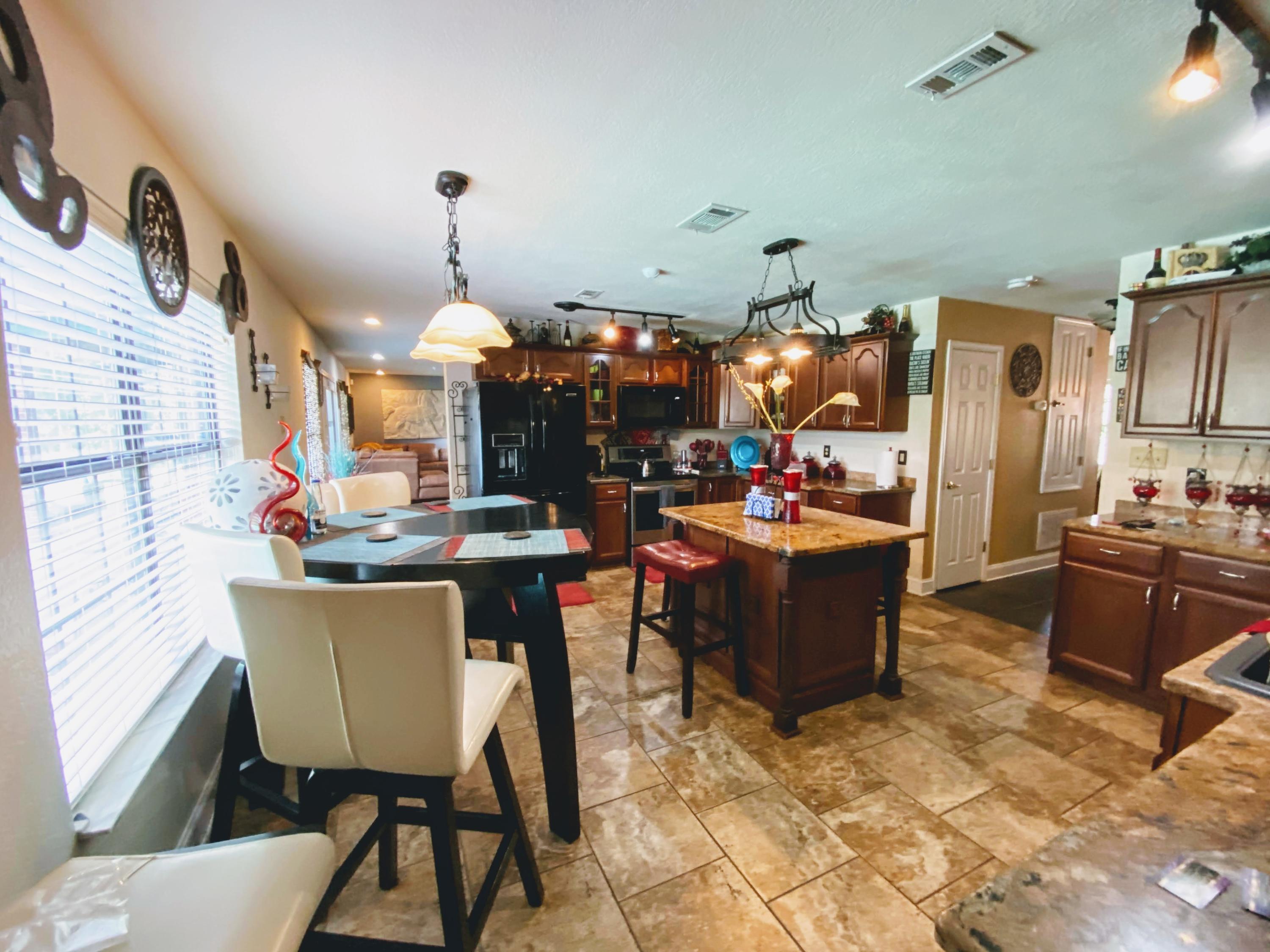 100 Sioux Circle Crestview, FL 32536 - Photo 32 of 36 a living room with lots of furniture and chandelier