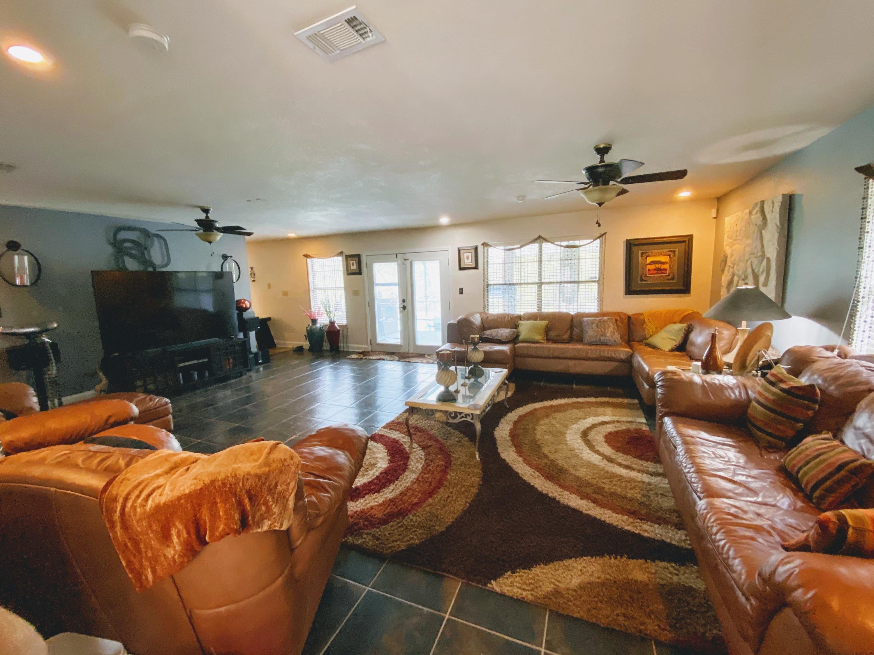 100 Sioux Circle Crestview, FL 32536 - Photo 4 of 36 a living room with furniture a fireplace and a flat screen tv