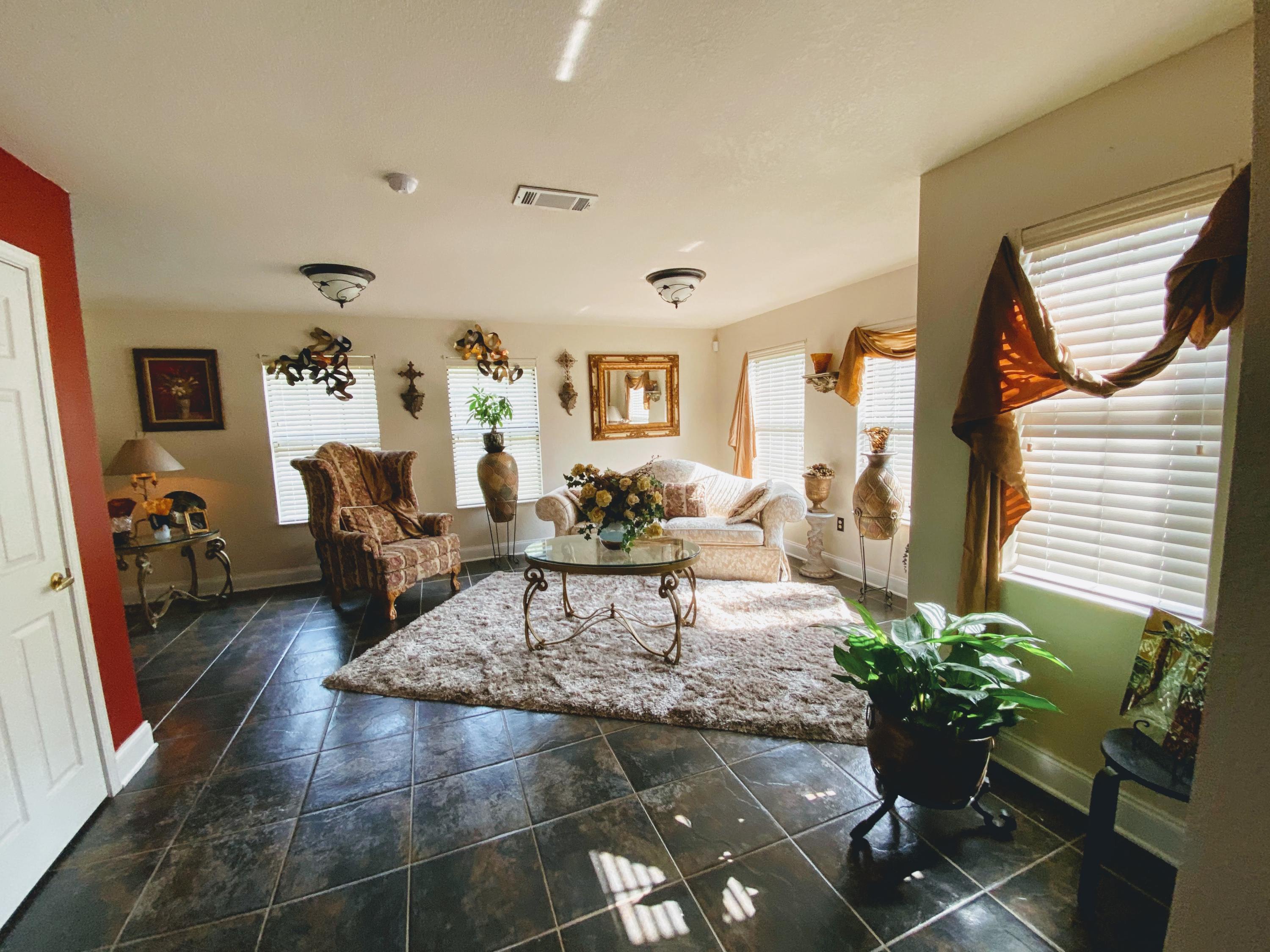 100 Sioux Circle Crestview, FL 32536 - Photo 6 of 36 a living room with furniture flowerpot and a potted plant