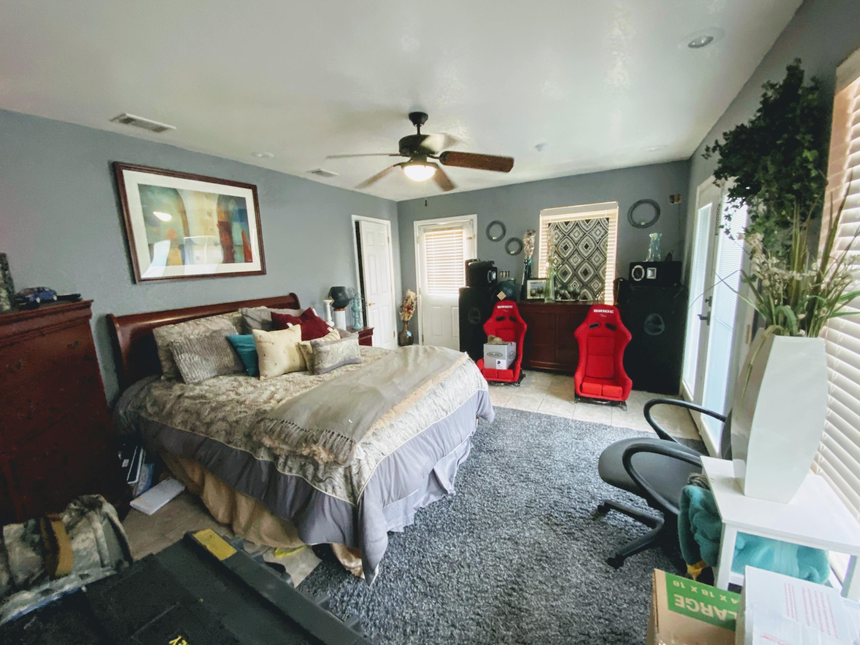 100 Sioux Circle Crestview, FL 32536 - Photo 9 of 36 a bed room with a bed mirror and a chandelier