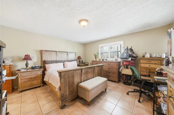 a bedroom with a bed and flat screen tv