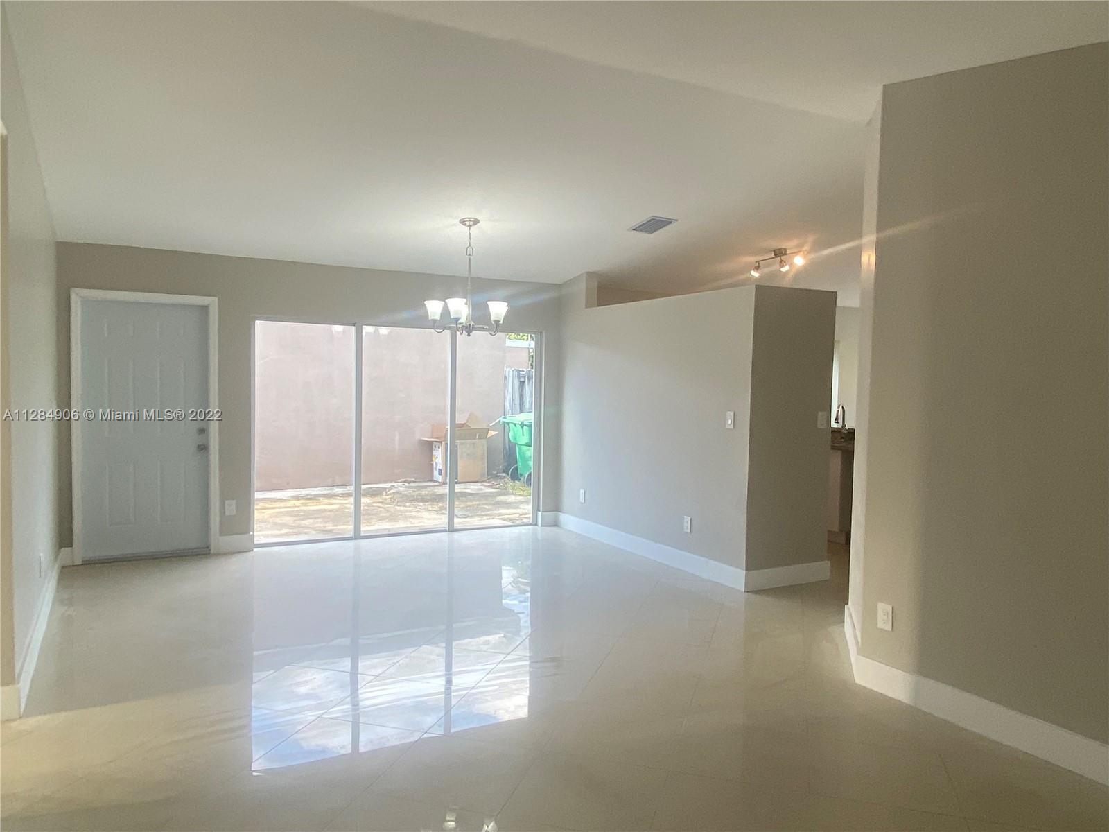 17501 Southwest 142nd Court Miami, FL 33177 - Photo 1 of 8 an empty room with large windows