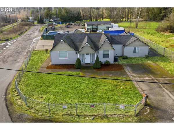 a aerial view of a house with swimming pool and a yard