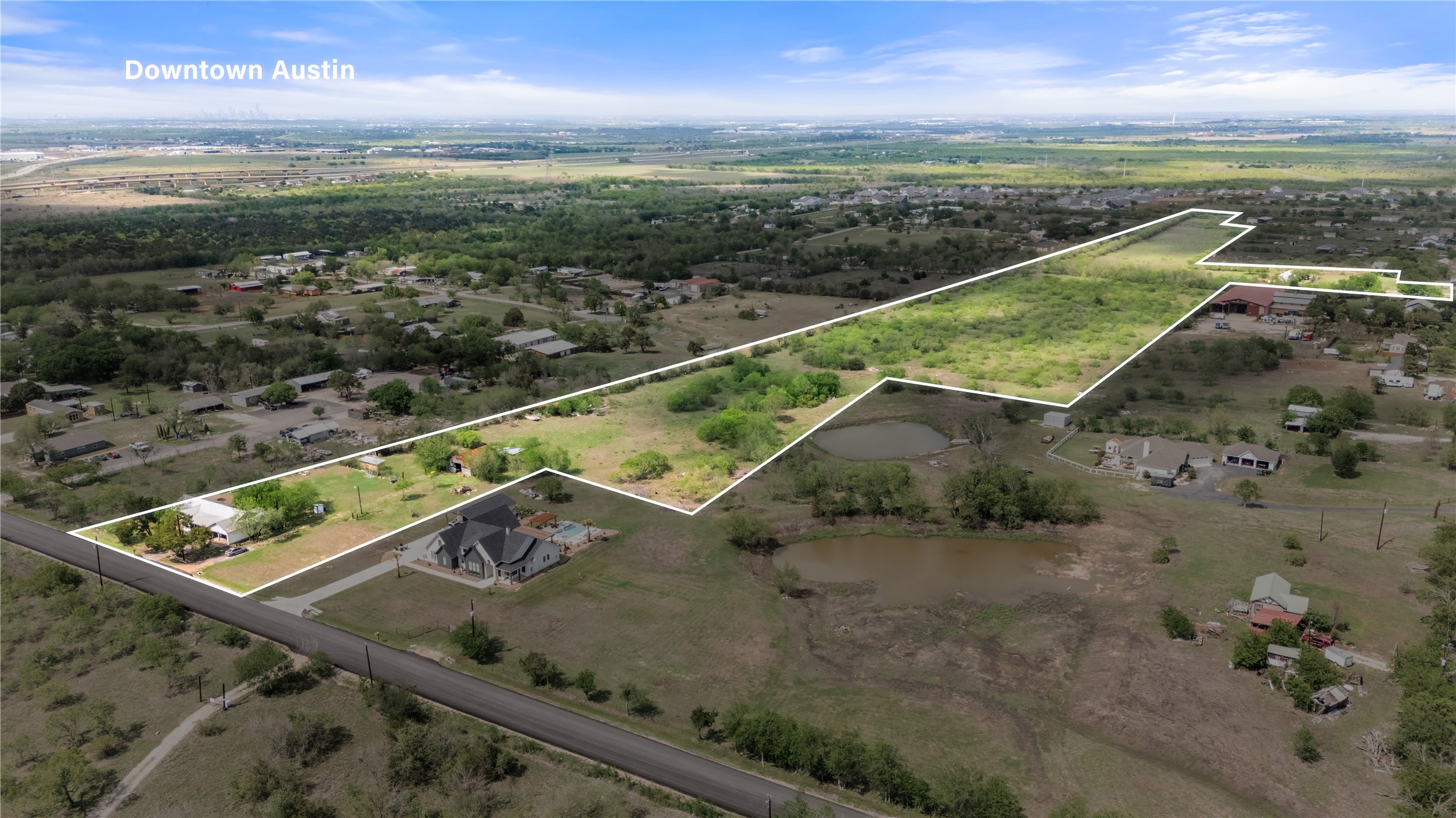 8802 Evelyn Road Buda, TX 78610 - Photo 12 of 13 Expansive aerial property featuring a long, irregular lot outline with a clear boundary, and scattered tree coverage