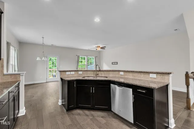 a kitchen with a sink a microwave a stove and refrigerator