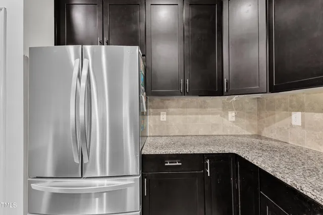 a kitchen with a refrigerator and sink