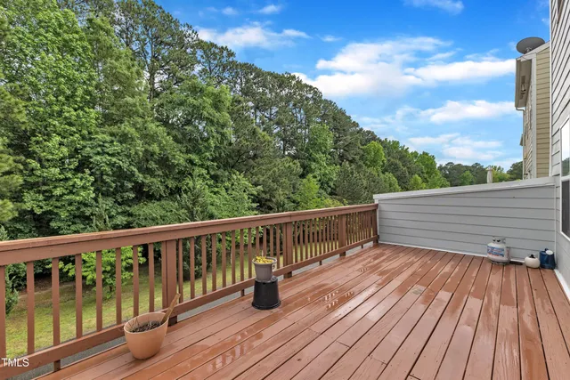 a view of roof deck with wooden floor and fence
