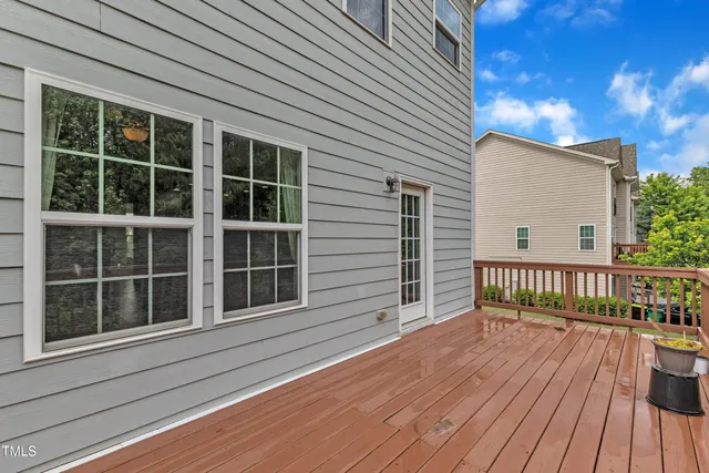 a view of balcony with wooden floor and fence
