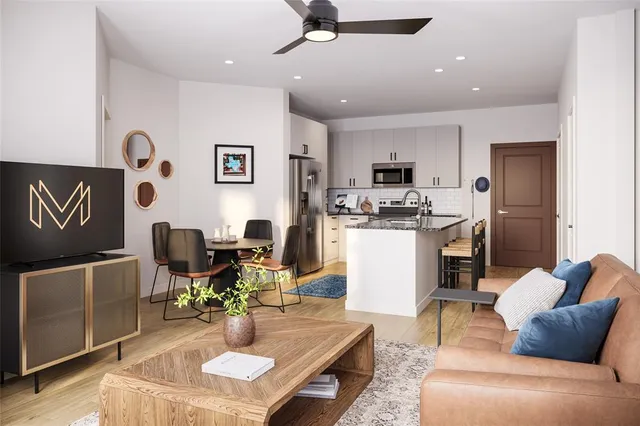 a living room with furniture and kitchen view