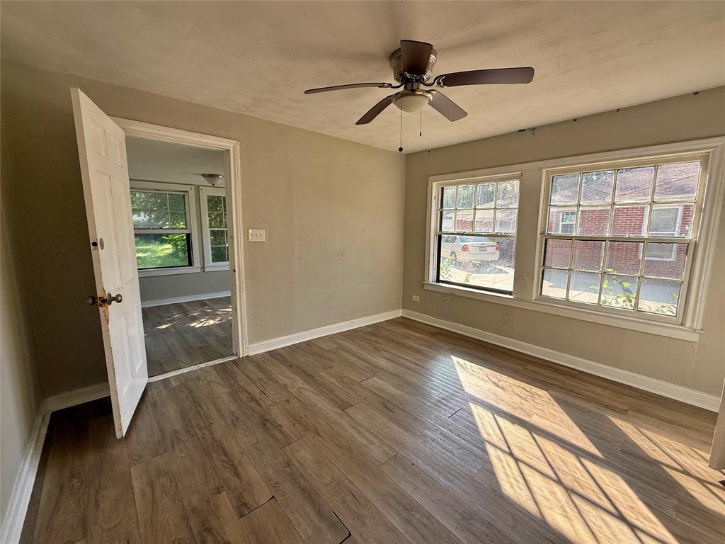 607 La Clede Street Bellmead, TX 76705 - Photo 7 of 7 Unfurnished room featuring dark wood-type flooring and ceiling fan
