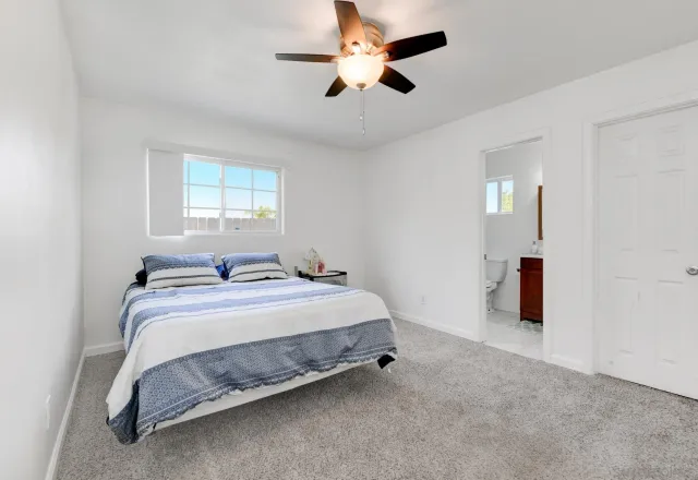 a bedroom with bed and a chandelier