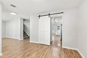 a view of hallway with wooden floor