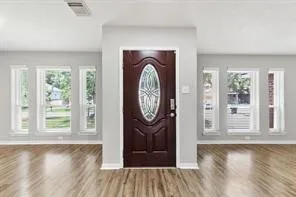 a view of a room with wooden floor fireplace and a window