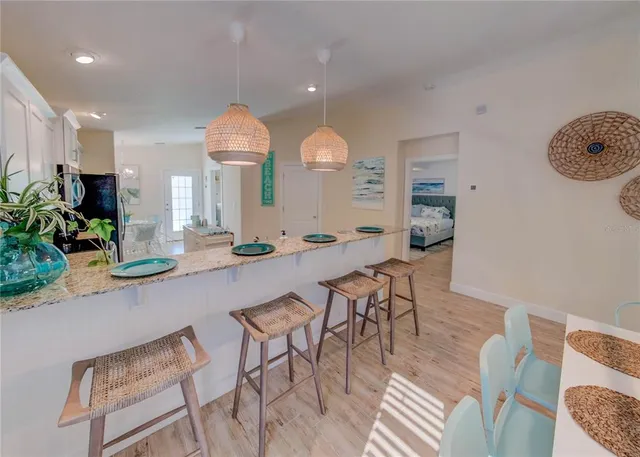 a view of kitchen with granite countertop cabinets and wooden floor