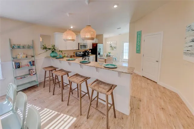 a kitchen with granite countertop a sink a counter top space and cabinets