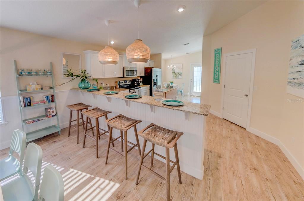 27 Mala Compra Road Palm Coast, FL 32137 - Photo 16 of 57 a view of a dining room with furniture window and wooden floor
