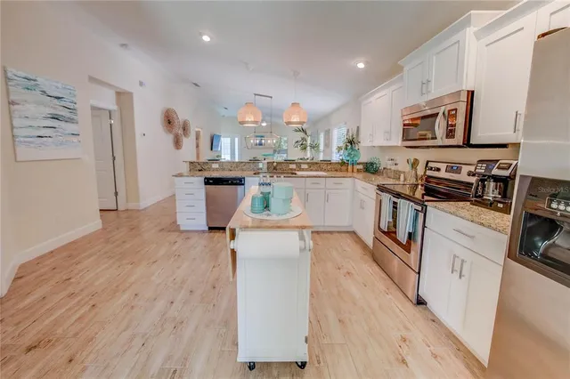a kitchen with a refrigerator and a stove
