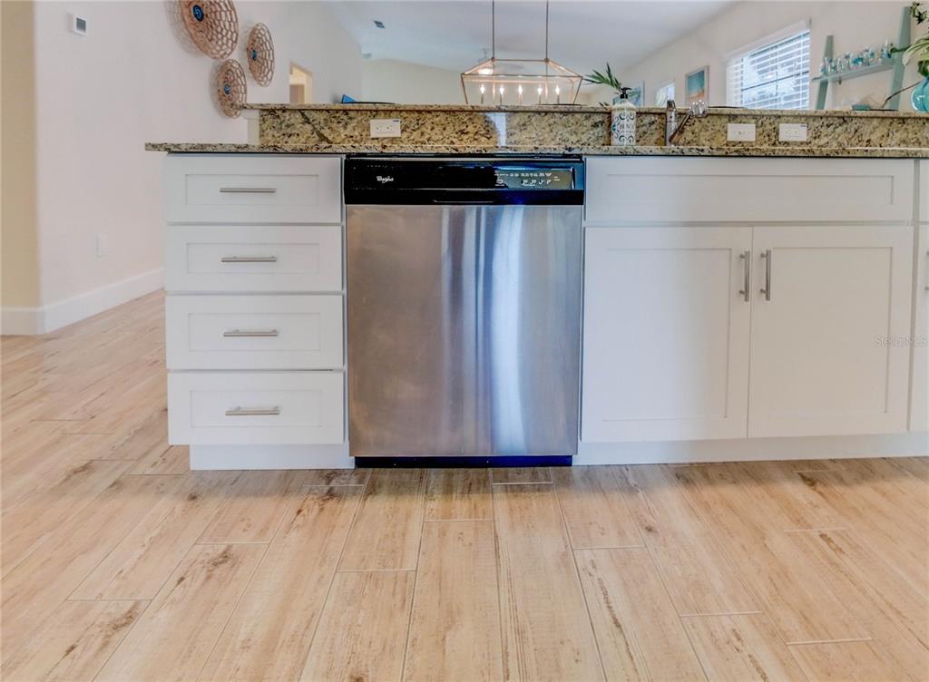 27 Mala Compra Road Palm Coast, FL 32137 - Photo 19 of 57 a view of kitchen with granite countertop cabinets and wooden floor