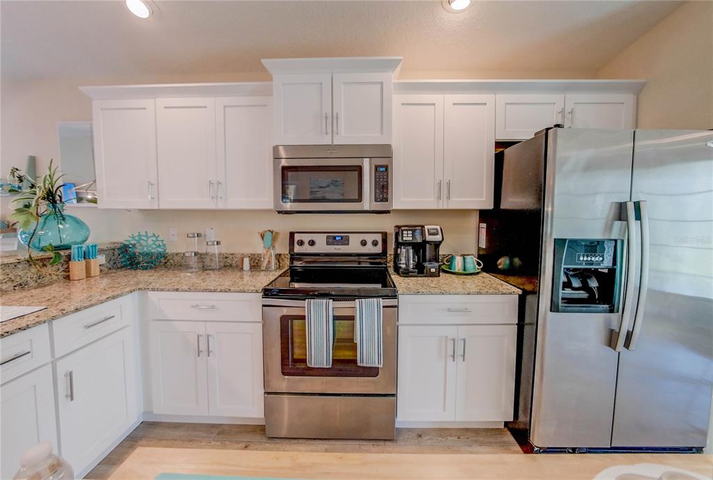 27 Mala Compra Road Palm Coast, FL 32137 - Photo 21 of 57 a kitchen with cabinets stainless steel appliances and a counter space