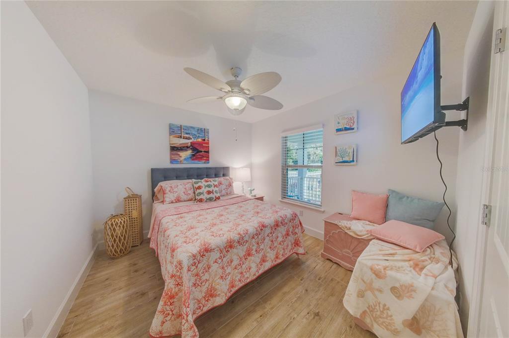 27 Mala Compra Road Palm Coast, FL 32137 - Photo 24 of 57 a bedroom with a bed and a chandelier