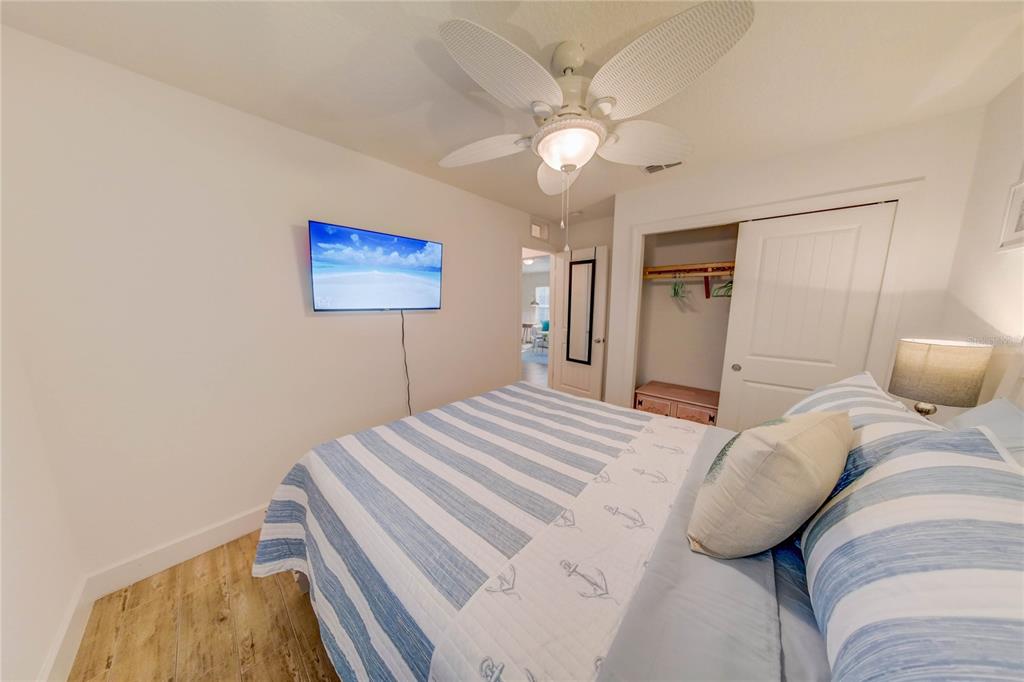 27 Mala Compra Road Palm Coast, FL 32137 - Photo 32 of 57 a bedroom with a bed and a painting on the wall