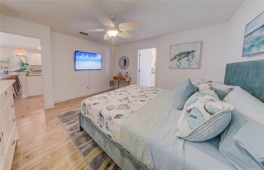 27 Mala Compra Road Palm Coast, FL 32137 - Photo 34 of 57 a bedroom with a bed and a chandelier
