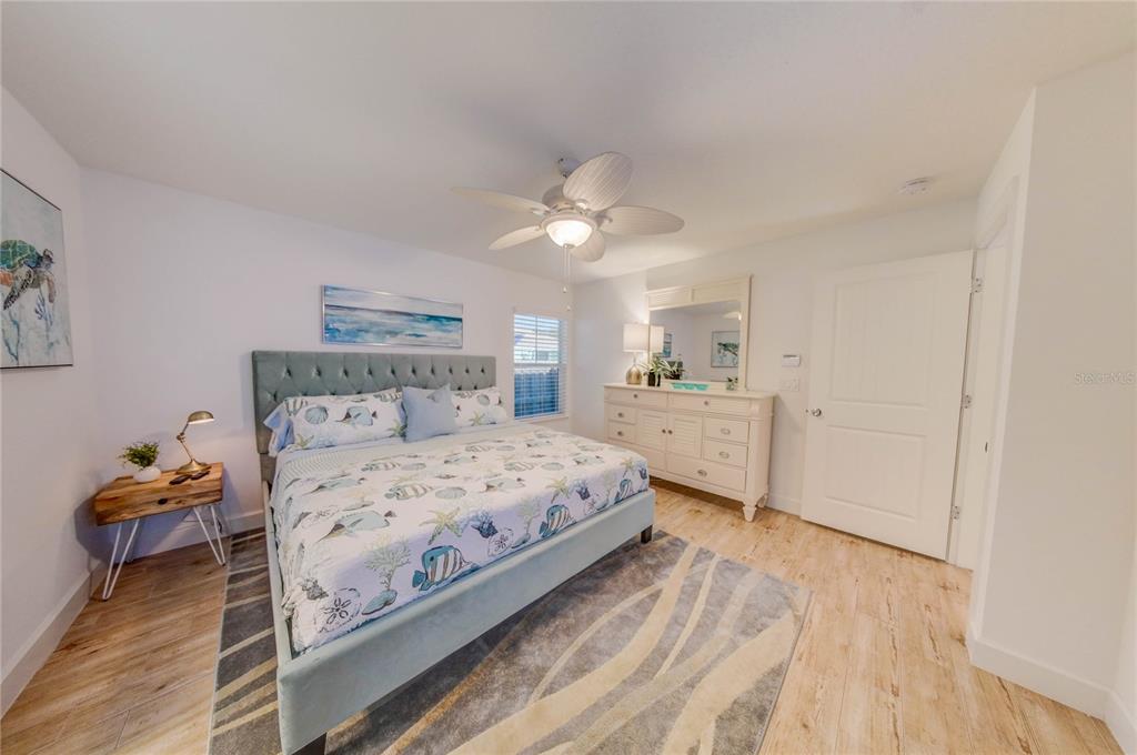 27 Mala Compra Road Palm Coast, FL 32137 - Photo 36 of 57 a bedroom with a bed and a chandelier