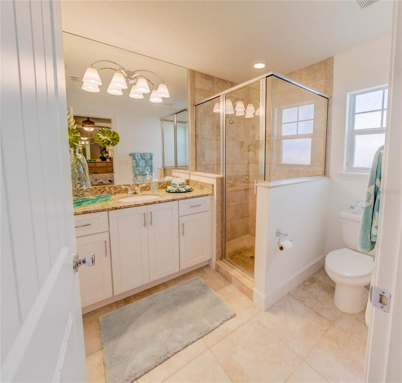 27 Mala Compra Road Palm Coast, FL 32137 - Photo 39 of 57 a bathroom with a sink a toilet and a mirror