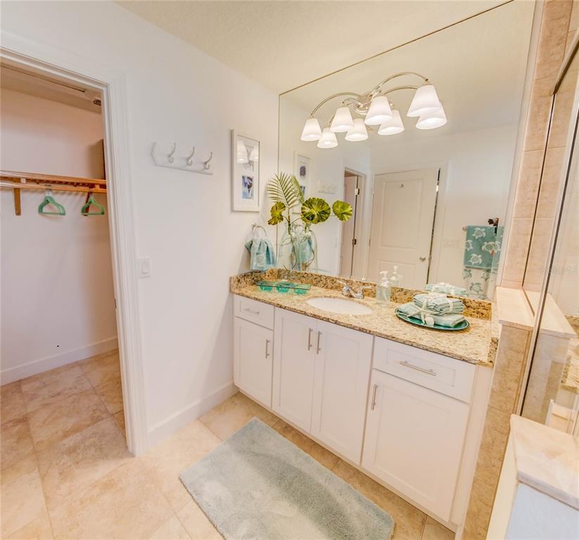 27 Mala Compra Road Palm Coast, FL 32137 - Photo 40 of 57 a bathroom with a double vanity sink and a mirror