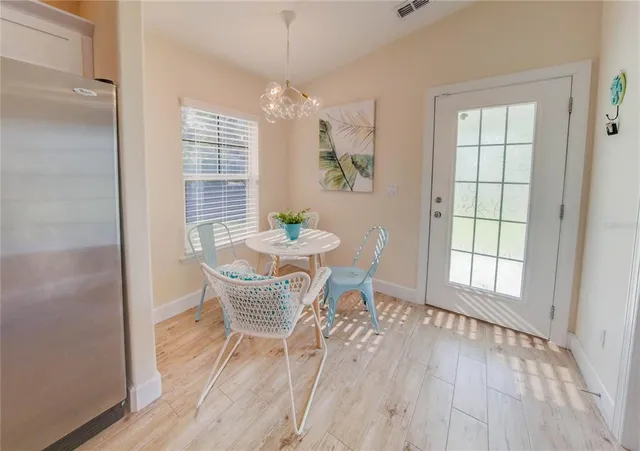 a backyard of a house with table and chairs