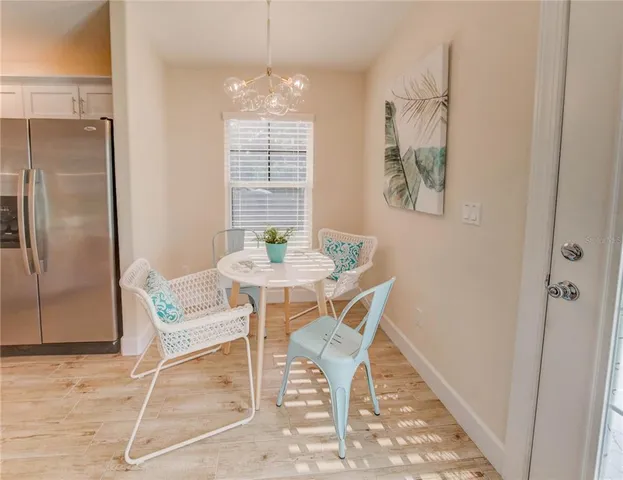 a dining room with furniture and wooden floor