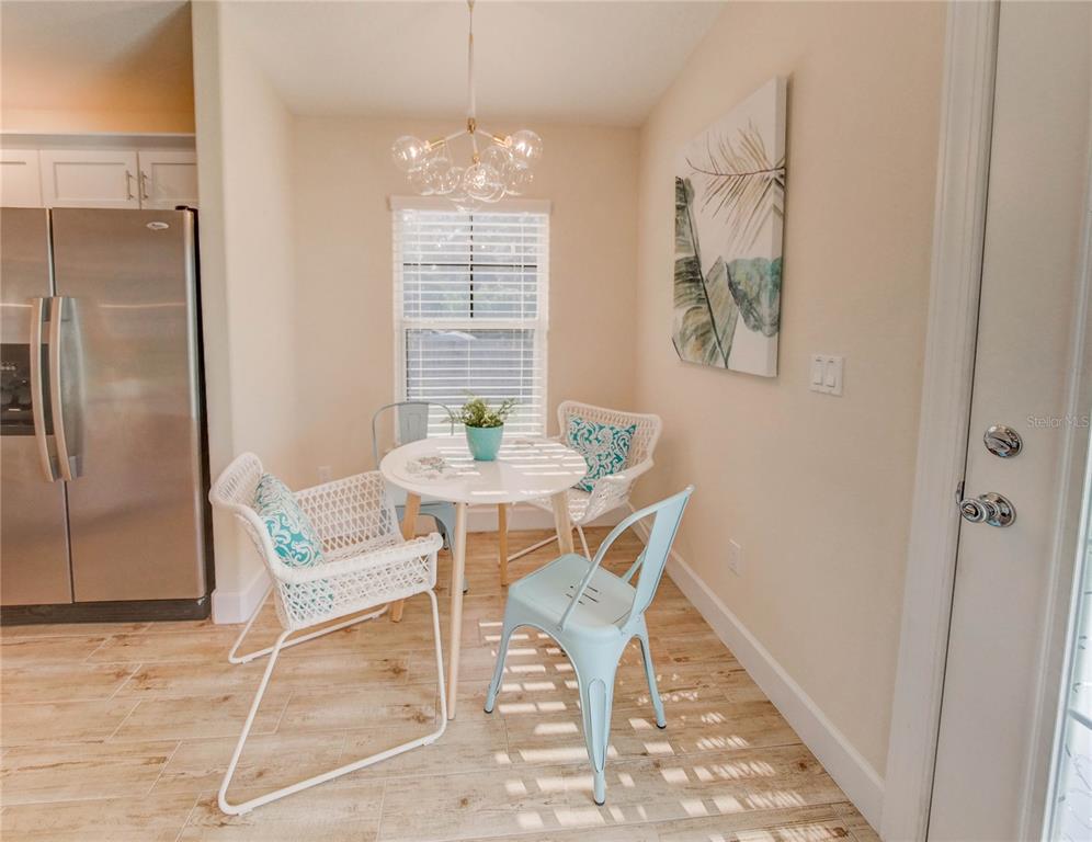 27 Mala Compra Road Palm Coast, FL 32137 - Photo 45 of 57 a view of a dining room with furniture a chandelier and wooden floor