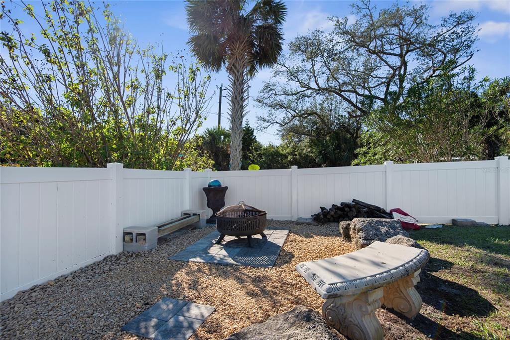 27 Mala Compra Road Palm Coast, FL 32137 - Photo 50 of 57 a backyard of a house with table and chairs