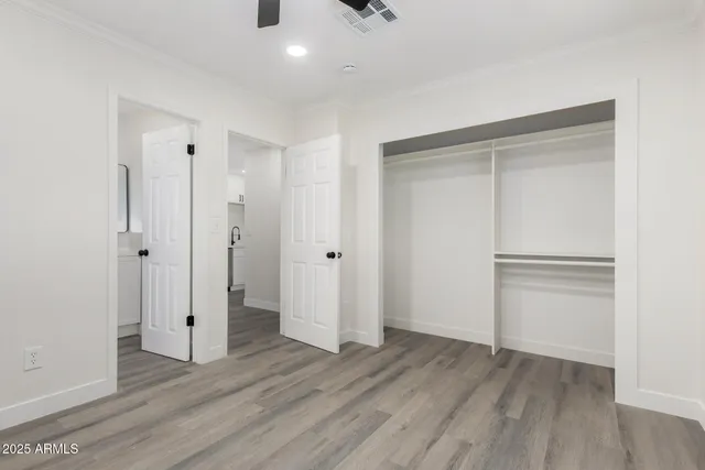 a view of an empty room with wooden floor