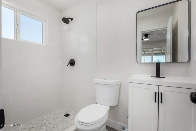 a white toilet sitting next to a bathroom sink